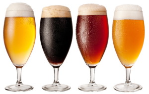 Four glasses with different beers on a white background. The file contains a path to cut.